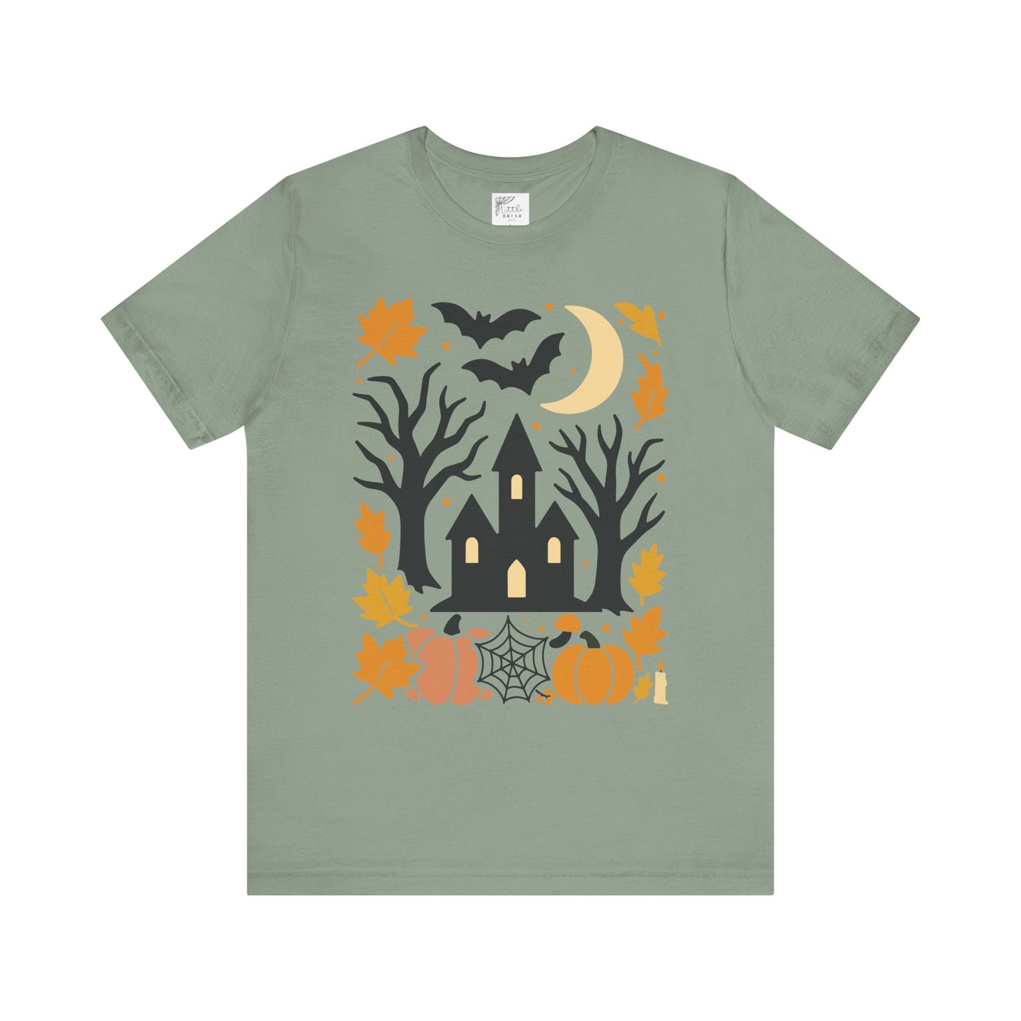 Unisex t-shirt with a haunted house, pumpkins, bats, and full moon Halloween graphic. halloween tee