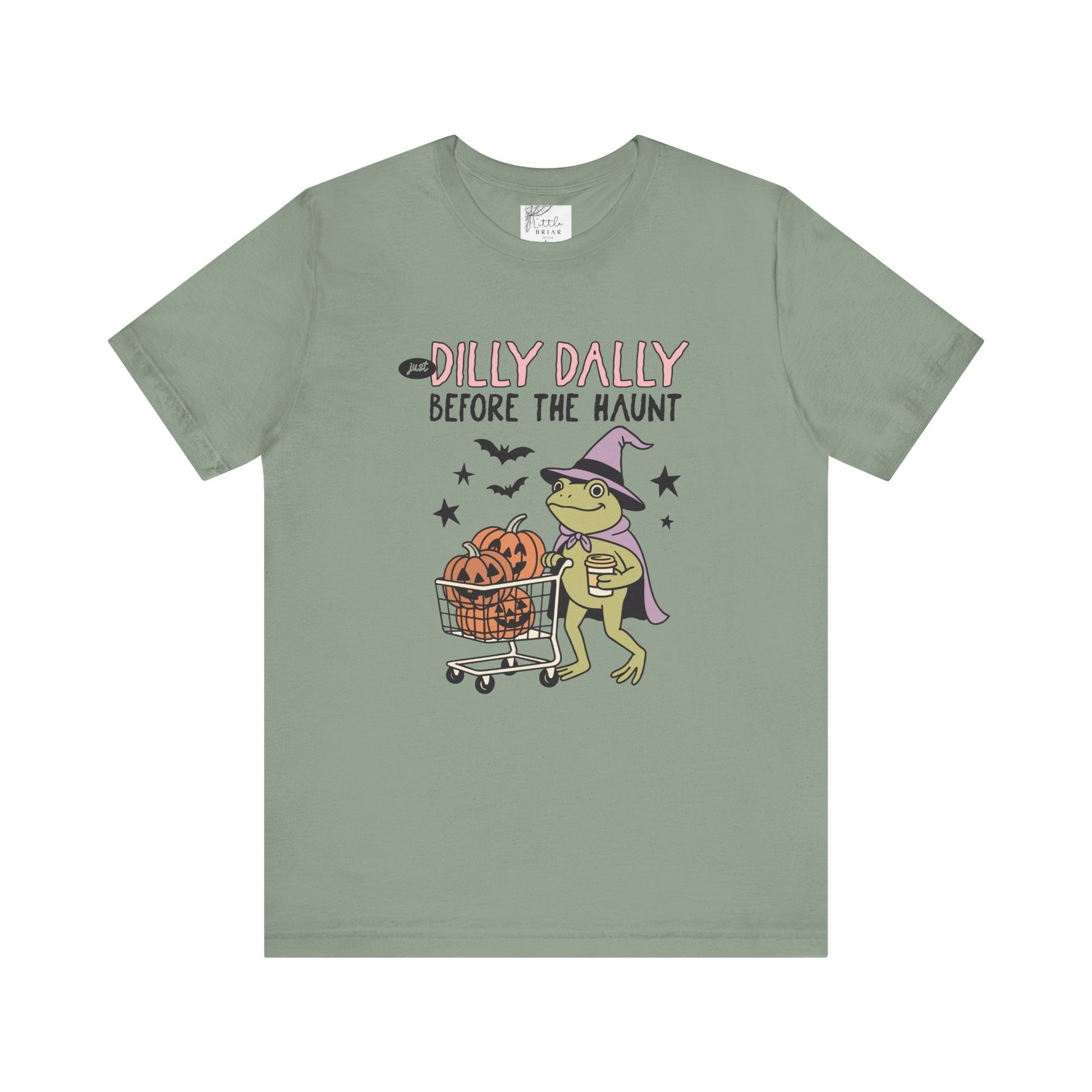 Green t-shirt with Halloween-themed graphic and text on a white background 
dilly dally  frog and pumpkin